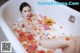 A woman laying in a bathtub filled with flowers.