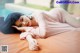 A woman laying on top of a bed next to a pool.