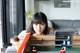 A woman sitting at a table with a foosball table.