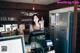 A woman standing behind a counter in a restaurant.